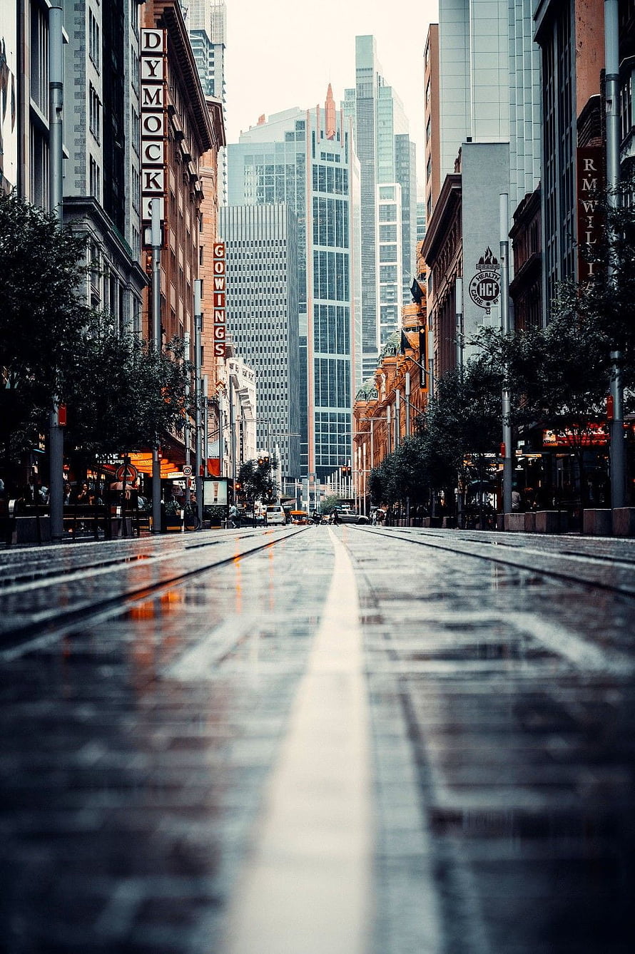 Moody Wet Street in Melbourne CBD with Skyscrapers and Tram Tracks HD phone wallpaper