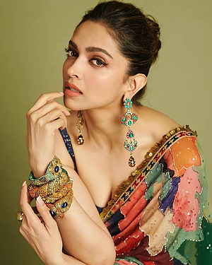 Deepika Padukone in a vibrant embroidered saree with ornate gold and turquoise jewelry HD phone wallpaper