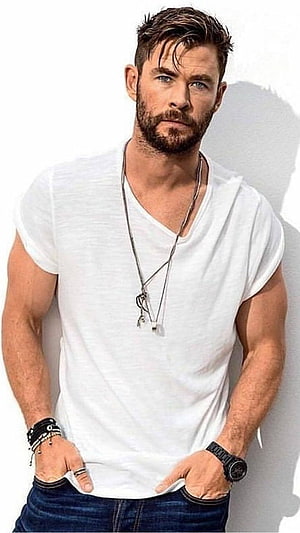 Chris Hemsworth in White V-Neck Tee and Denim Jeans with Layered Necklaces HD phone wallpaper
