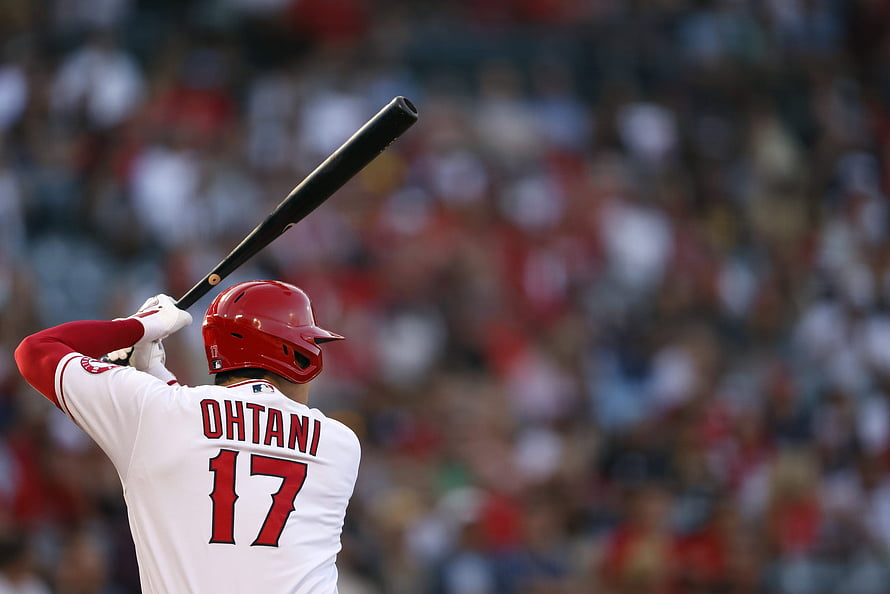 Shohei Ohtani in Angels uniform holding bat at home plate during a baseball game HD wallpaper