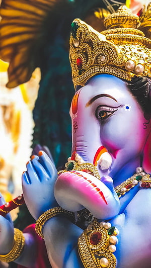 Ornate Ganesha Murti with Golden Crown and Jeweled Adornments in Devotional Pose HD phone wallpaper