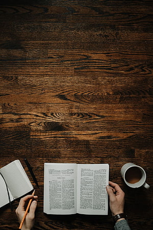 Open Bible on a Dark Wood Desk with Coffee Mug and Notebook HD phone wallpaper