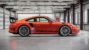 Orange Porsche 911 GT3 RS Side Profile in Industrial Warehouse Setting HD wallpaper