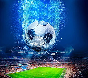 Soccer Ball Bursting Through Water Above a Packed Stadium HD wallpaper