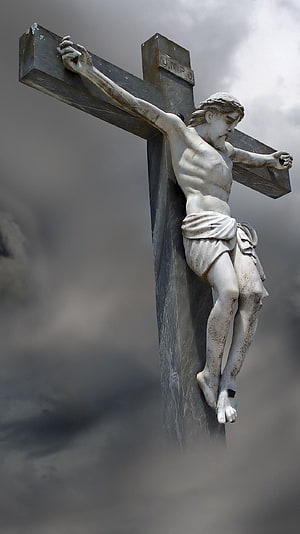 Weathered Stone Statue of Jesus Christ on the Cross Against a Dramatic Cloudy Sky HD phone wallpaper