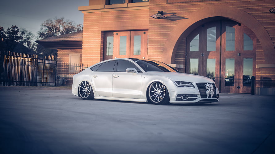 White Audi A7 Sportback with Vossen Wheels Parked in Front of Brick Building HD wallpaper