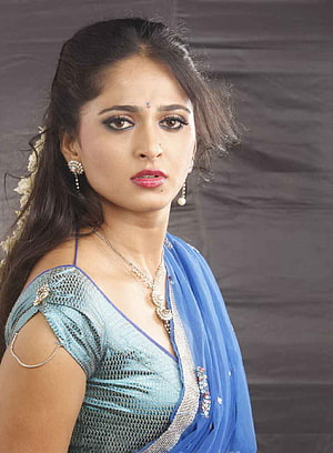 Anushka Shetty in a Blue Saree with Traditional Jewelry and Studio Portrait HD phone wallpaper