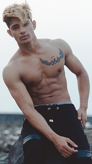 Danish Zehen shirtless portrait with chest tattoo and blonde hair by the water HD phone wallpaper