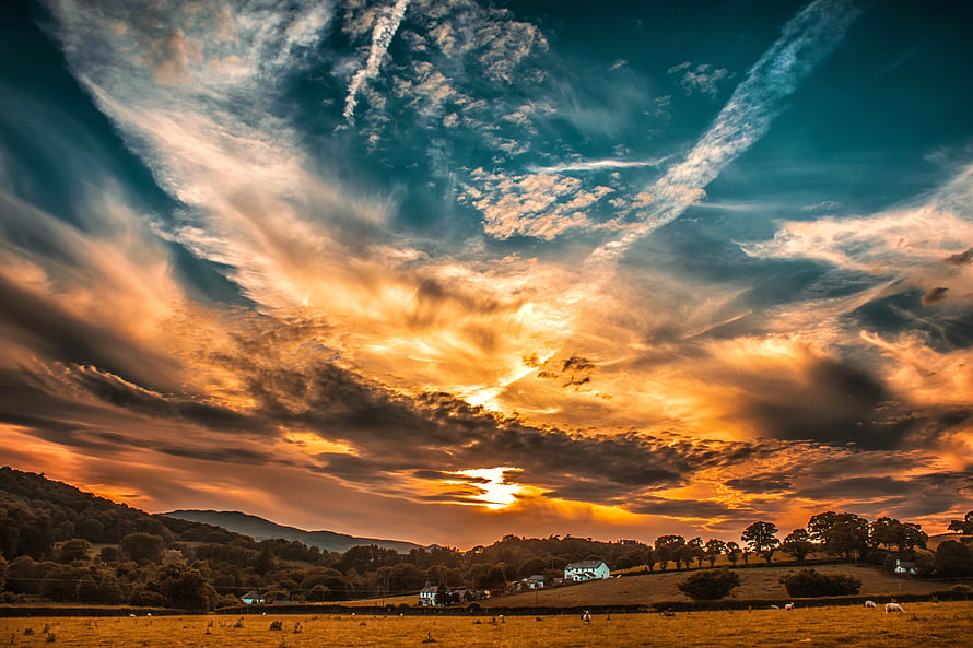Dramatic Golden Sunset Over Rolling Countryside Hills and Pasture Fields HD wallpaper