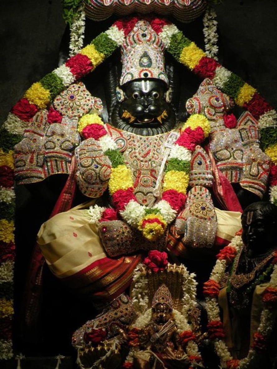 Lord Narasimha Murti Adorned With Vibrant Flower Garlands And Ornate Temple Jewelry HD phone wallpaper