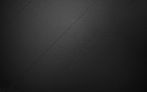 Dark Textured Leather Surface with Diagonal Stitching and Subtle Vignette HD wallpaper