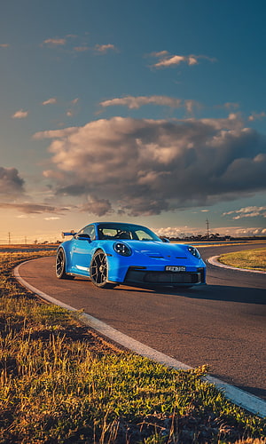 Blue Porsche 911 GT3 on a Curved Track at Golden Hour HD phone wallpaper