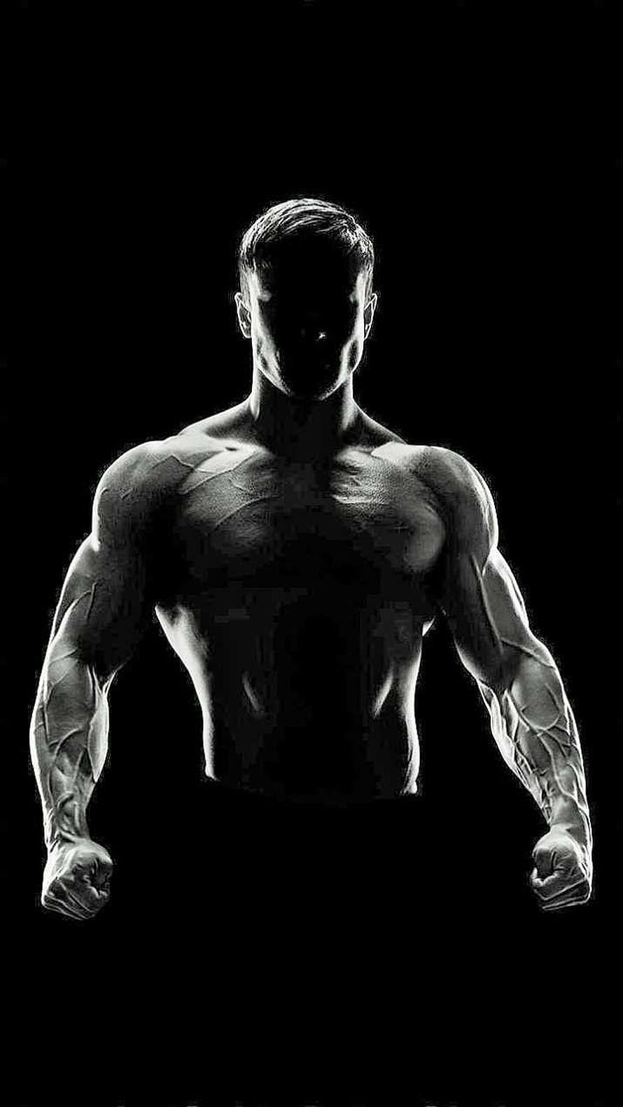 Black and White Silhouette of a Muscular Bodybuilder Flexing in the Dark HD phone wallpaper