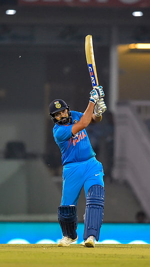 Rohit Sharma in India Blue Kit Executing a Powerful Cricket Batting Stroke HD phone wallpaper