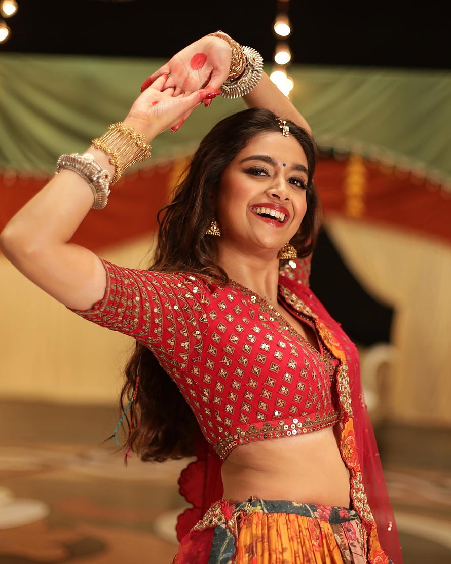 Keerthy Suresh in a red embroidered lehenga performing a traditional Indian dance HD phone wallpaper