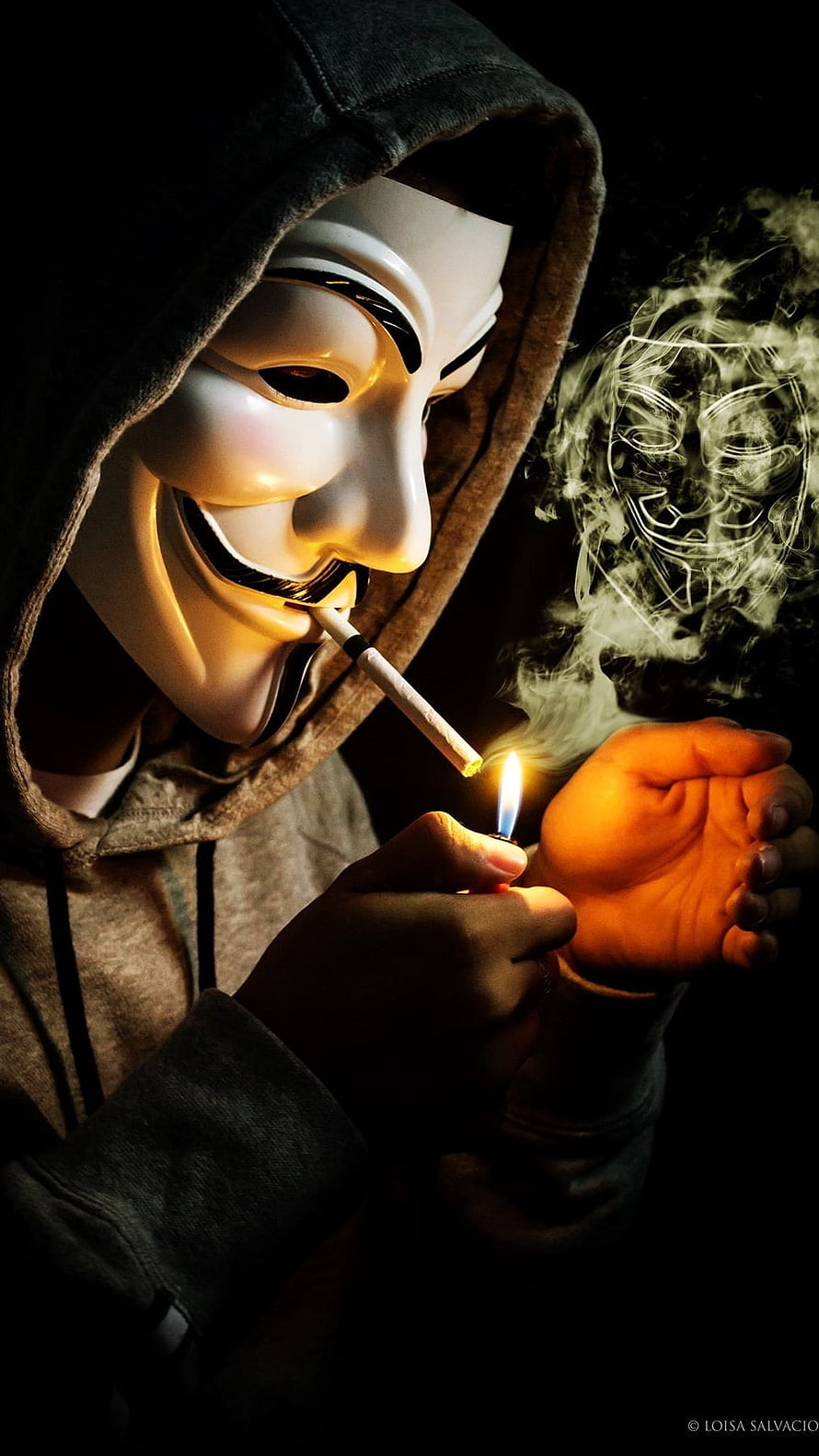 Guy Fawkes Mask Wearer Lighting Cigarette in Hoodie with Dramatic Smoke HD phone wallpaper