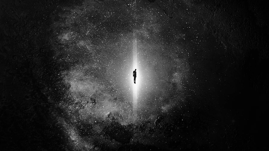 Silhouette of a lone figure standing in a vertical beam of light within a dark cosmic void HD wallpaper