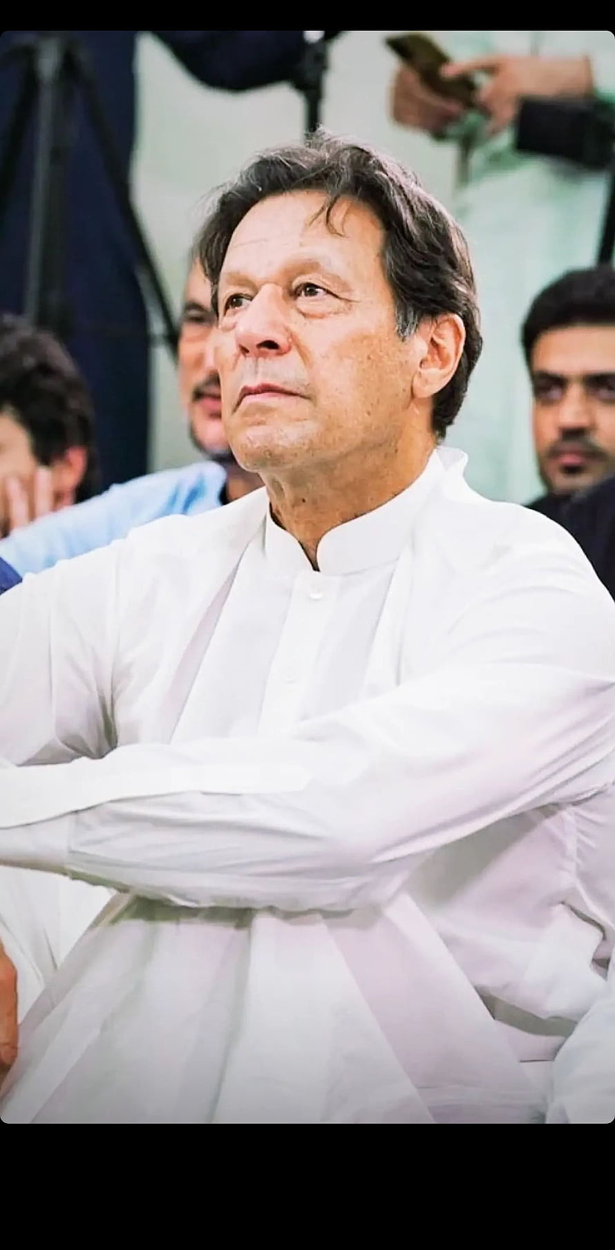 Imran Khan in a white shalwar kameez with arms crossed at a public event HD phone wallpaper