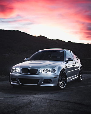 Silver BMW E46 M3 Coupe with Angel Eyes Under a Vibrant Sunset Sky HD phone wallpaper