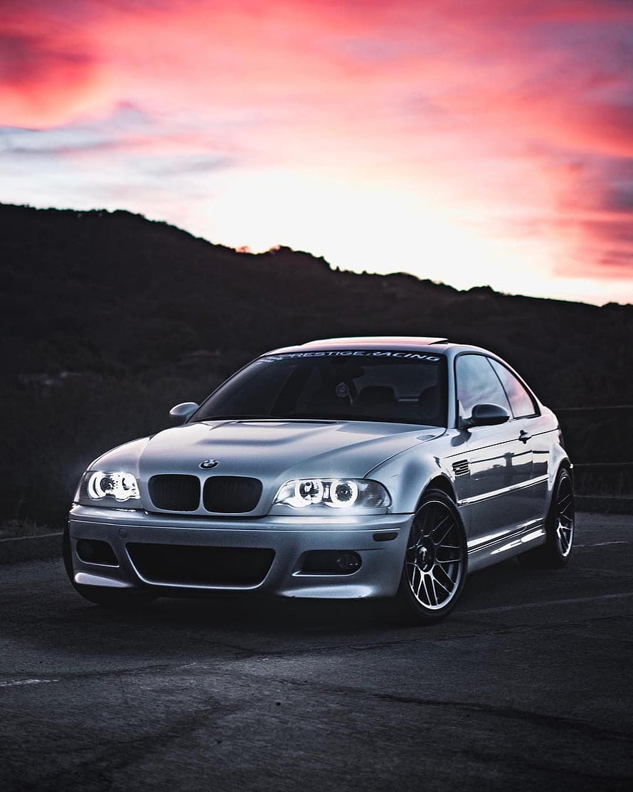 Silver BMW E46 M3 Coupe with Angel Eyes Under a Vibrant Sunset Sky HD phone wallpaper