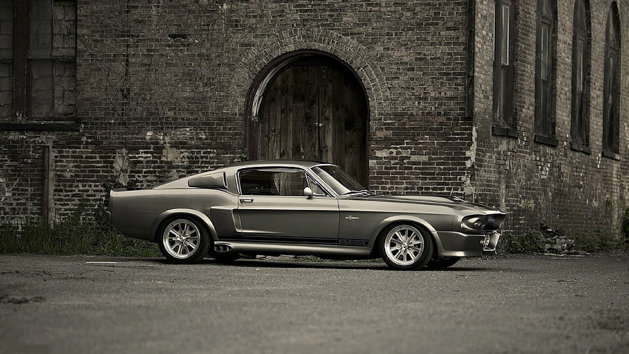 1967 Ford Mustang Shelby GT500 Eleanor in front of an abandoned brick building HD wallpaper