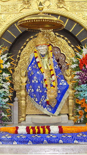 Shirdi Sai Baba Temple Murti Adorned in Blue Silk and Marigold Garlands HD phone wallpaper