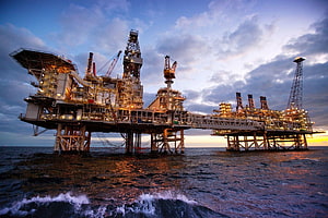 Offshore Oil and Gas Platform at Sunset with Industrial Drilling Rigs HD wallpaper