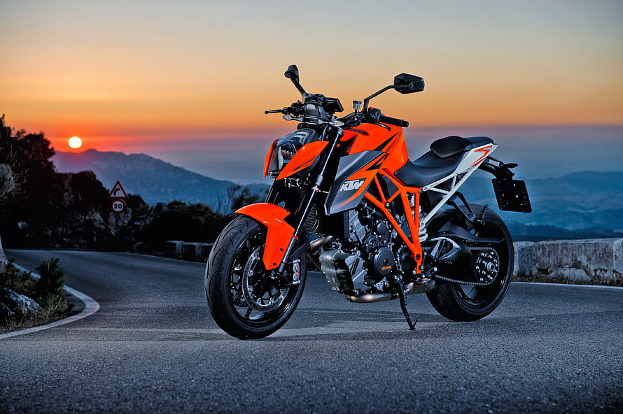 KTM 1290 Super Duke R Orange Naked Motorcycle on Mountain Road at Sunset HD wallpaper