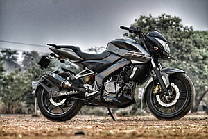 Bajaj Pulsar NS 200 Naked Motorcycle Parked on Gravel Road with Trees in Background HD wallpaper