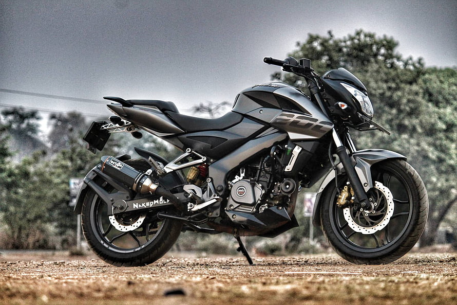 Bajaj Pulsar NS 200 Naked Motorcycle Parked on Gravel Road with Trees in Background HD wallpaper