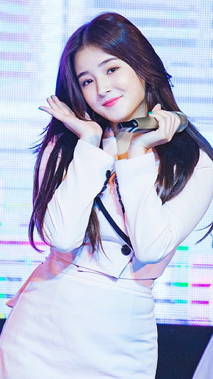 Nancy from Momoland performing on stage in a white outfit holding a microphone HD phone wallpaper