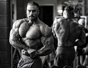 Chris Bumstead Bodybuilding Pose in Black and White Gym Portrait HD wallpaper