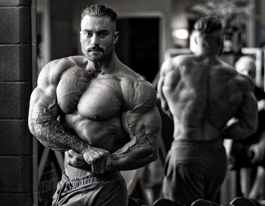 Chris Bumstead Bodybuilding Pose in Black and White Gym Portrait HD wallpaper