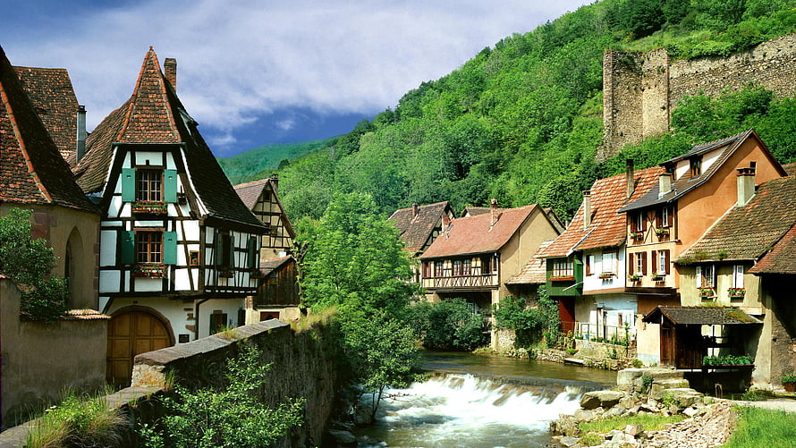 Charming European Mountain Village With Half-Timbered Houses And Flowing River HD wallpaper