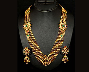 Traditional Indian Gold Necklace and Earring Set with Emerald and Ruby Accents HD wallpaper
