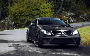 Matte Black Mercedes-Benz C63 AMG Coupe on a Forest Road HD wallpaper