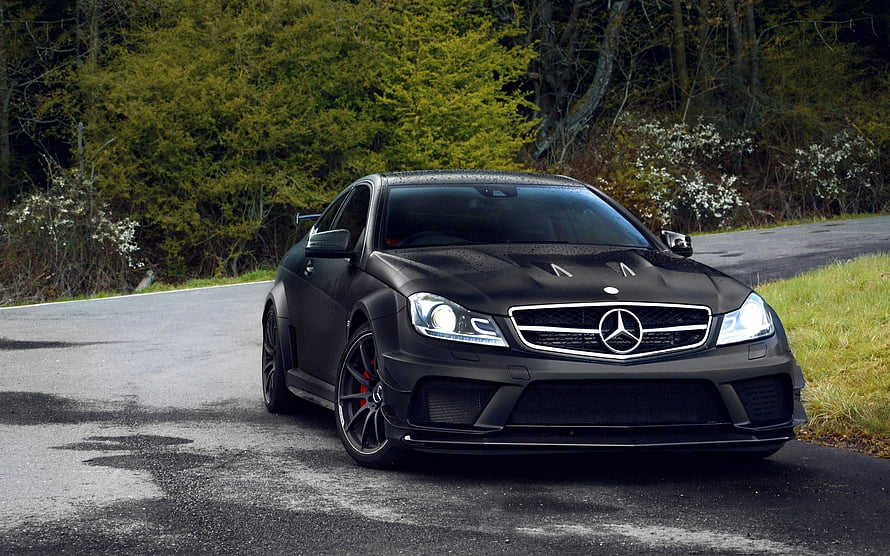 Matte Black Mercedes-Benz C63 AMG Coupe on a Forest Road HD wallpaper