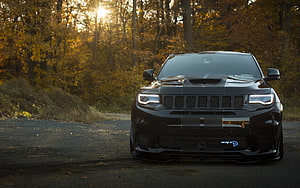 Black Jeep Grand Cherokee Trackhawk Front View on Forest Road at Sunset HD wallpaper