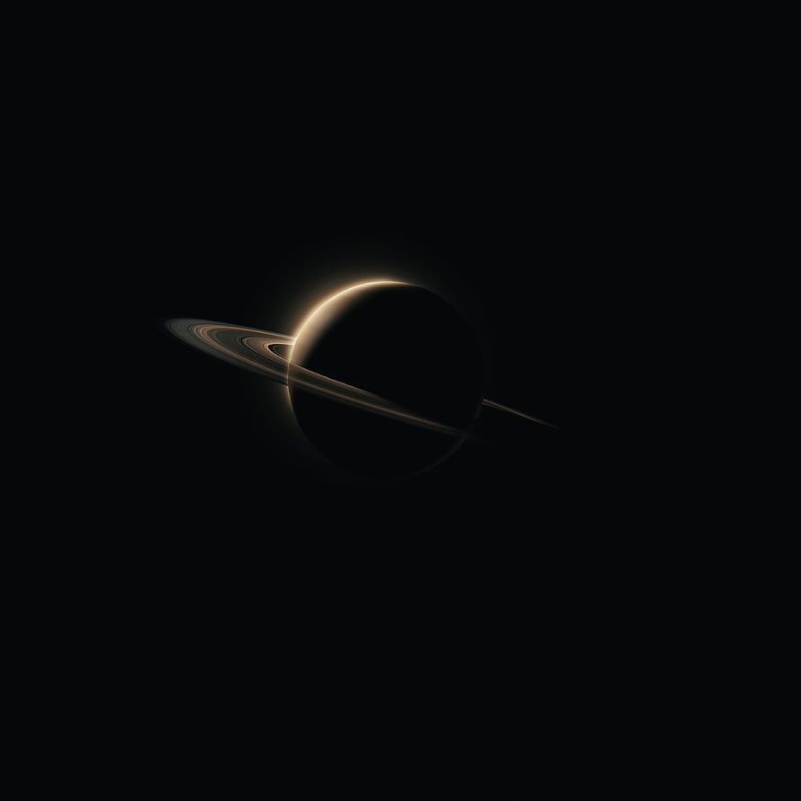 Minimalist Saturn with glowing rings set against a deep black cosmic background HD phone wallpaper