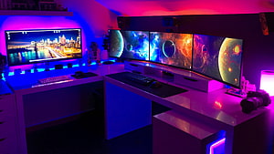 Multi-Monitor Gaming Desk with Neon RGB Lighting and Space Wallpapers HD wallpaper