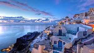 Santorini Cliffside Village at Dusk with Aegean Sea View HD wallpaper