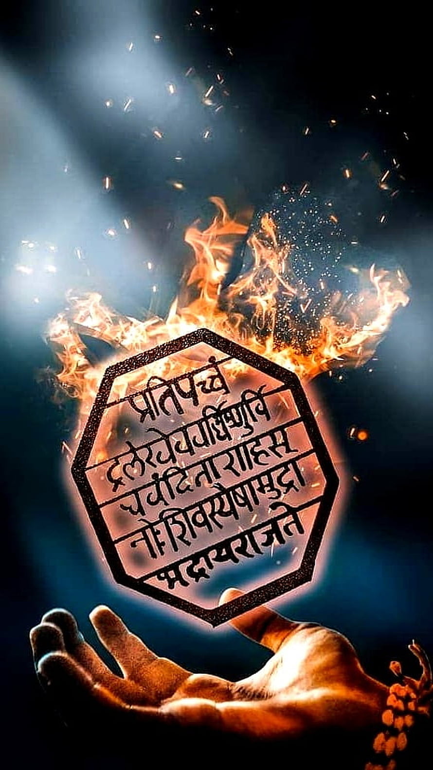 Flaming Octagonal Seal with Sanskrit Mantra Held in Open Palm Against Dark Background HD phone wallpaper