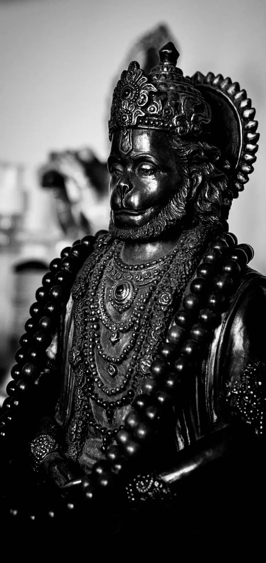 Black and White Hanuman Statue with Ornate Crown and Beaded Garland HD phone wallpaper