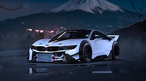 White BMW i8 widebody tuning on a wet road at night with a snow-capped mountain in the background HD wallpaper