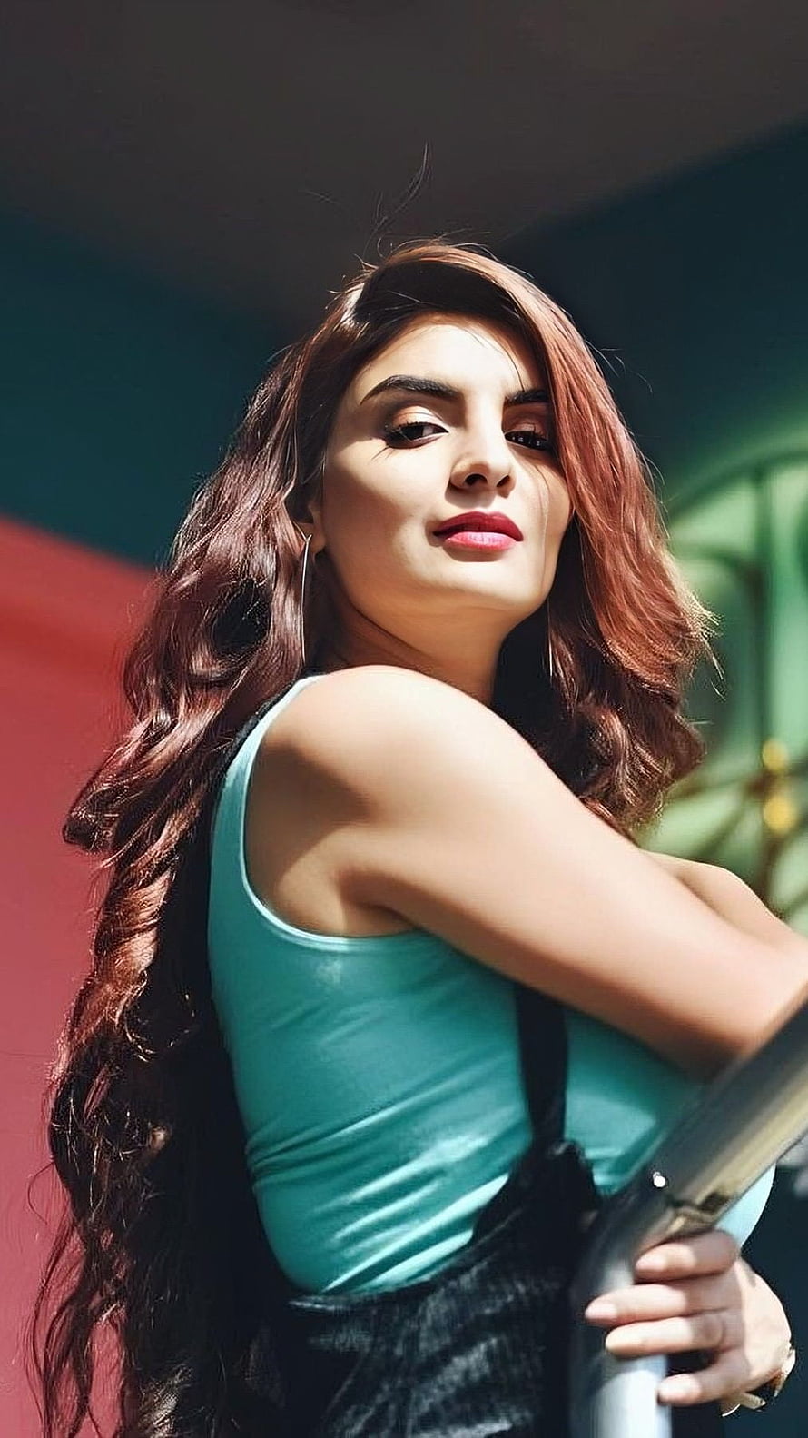 Anveshi Jain in a Teal Tank Top and Black Overalls with Long Wavy Hair HD phone wallpaper