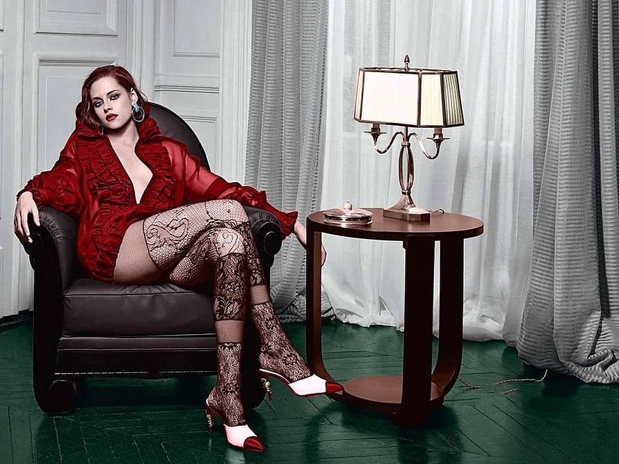 Kristen Stewart in red blouse and lace stockings seated in a leather armchair HD wallpaper