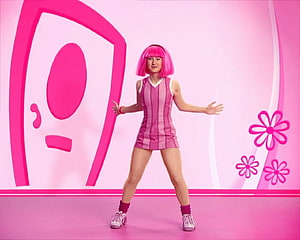 Stephanie from LazyTown in a pink striped dress and wig on a vibrant stage set HD wallpaper