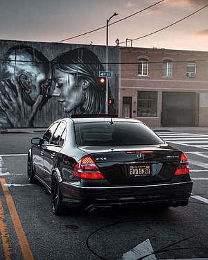 Black Mercedes-Benz E55 AMG W211 Sedan Parked on Urban Street at Dusk HD phone wallpaper