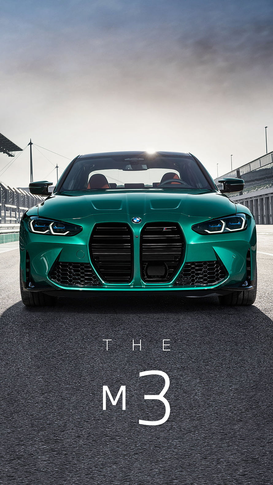 Front View of a Green BMW M3 on a Race Track Under a Dramatic Sky HD phone wallpaper