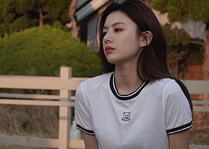 Go Yoon Jung in a white ringer t-shirt with a soft outdoor garden background HD wallpaper